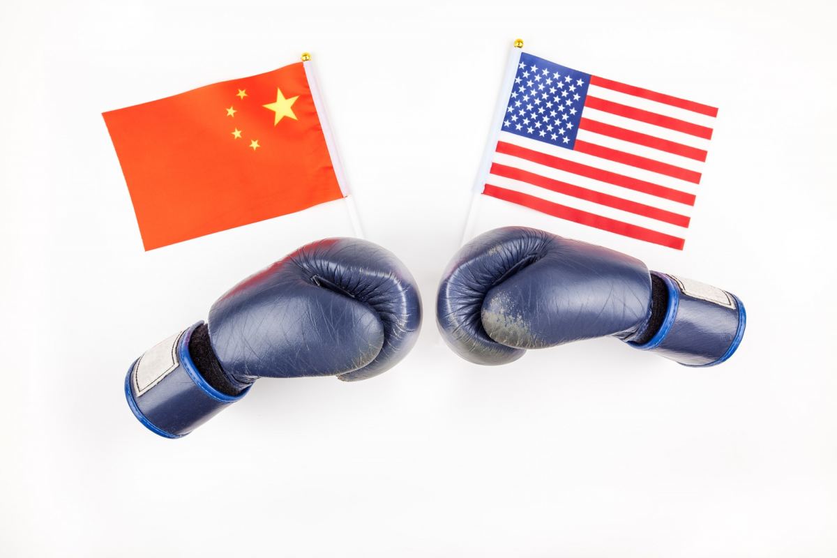 Creative top view flat lay of Two boxing gloves with China and USA flag and copy space on white