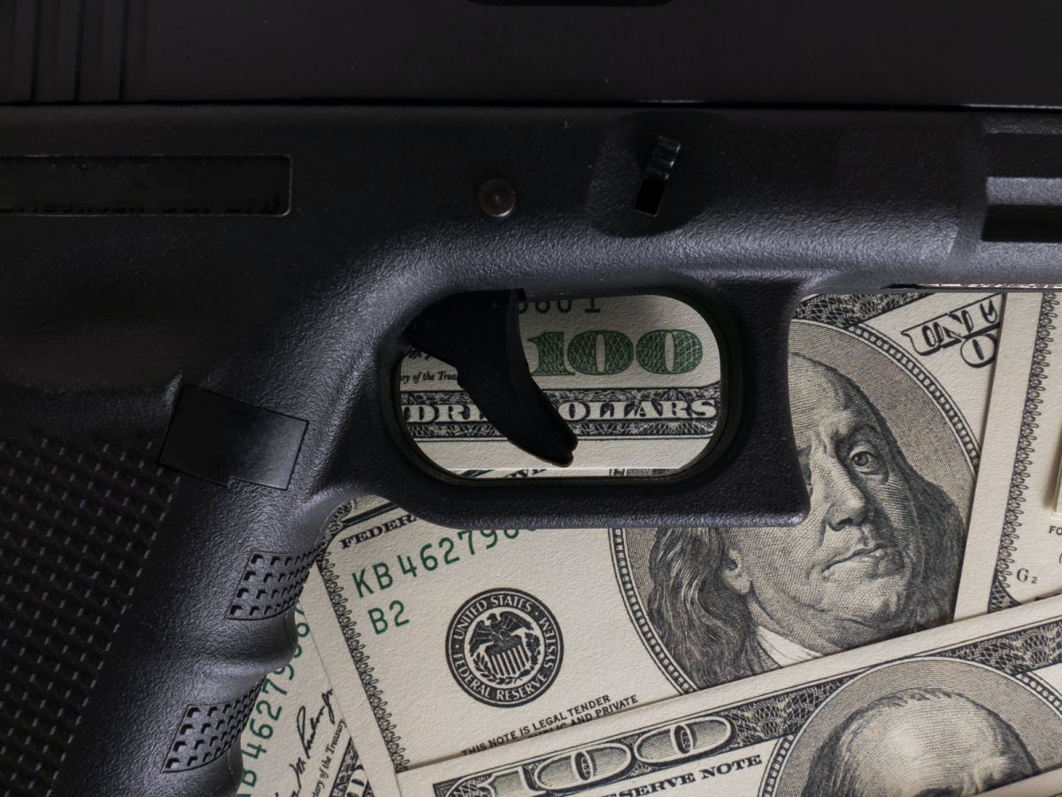 Gun on US dollar banknotes, crime and corruption.