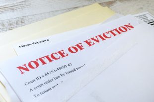 Side angle view of an official court ordered Eviction Notice in an envelope.