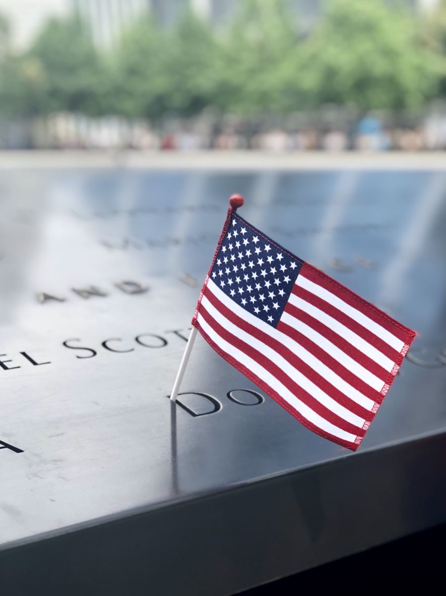 American flag on a name on the 911 World Trade Center Memorial