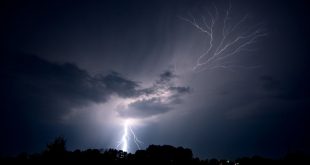 Lightning strikes the ground and spreads into the sky as a lightning crawler nears Jeanette,