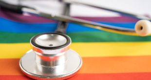 Black stethoscope on rainbow flag background, symbol of LGBT pride month celebrate annual in June