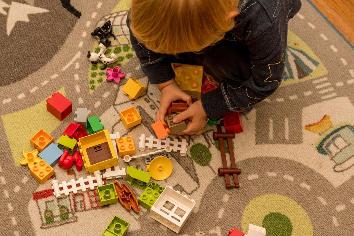 Toddler boy playing with construction blocks. Early development childcare preschool