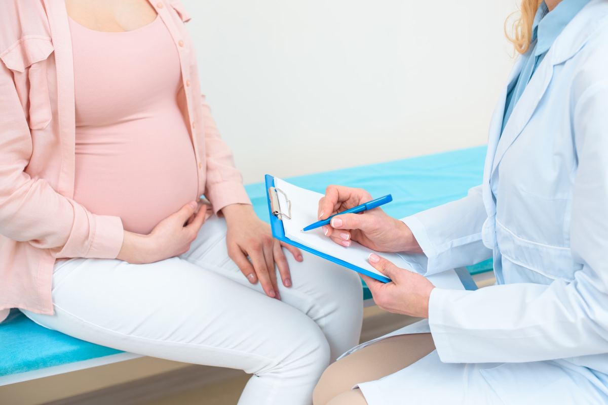 cropped shot of obstetrician gynecologist consulting pregnant woman at clinic
