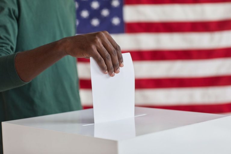 putting ballot in the box