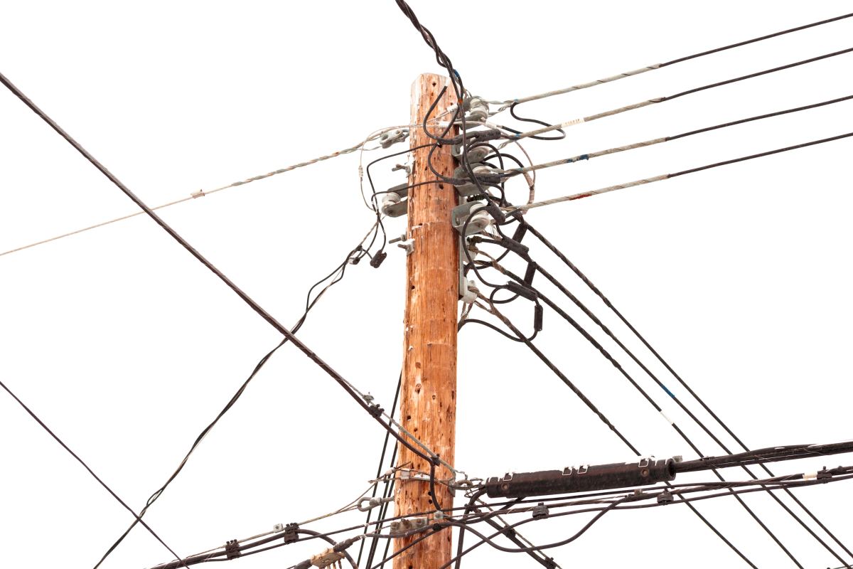 utility pole hung with electricity power cables