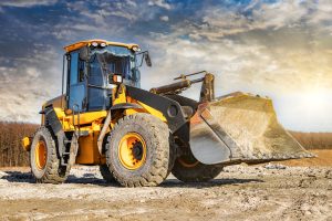 powerful,front,wheel,loader,or,bulldozer,working,on,a,quarry
